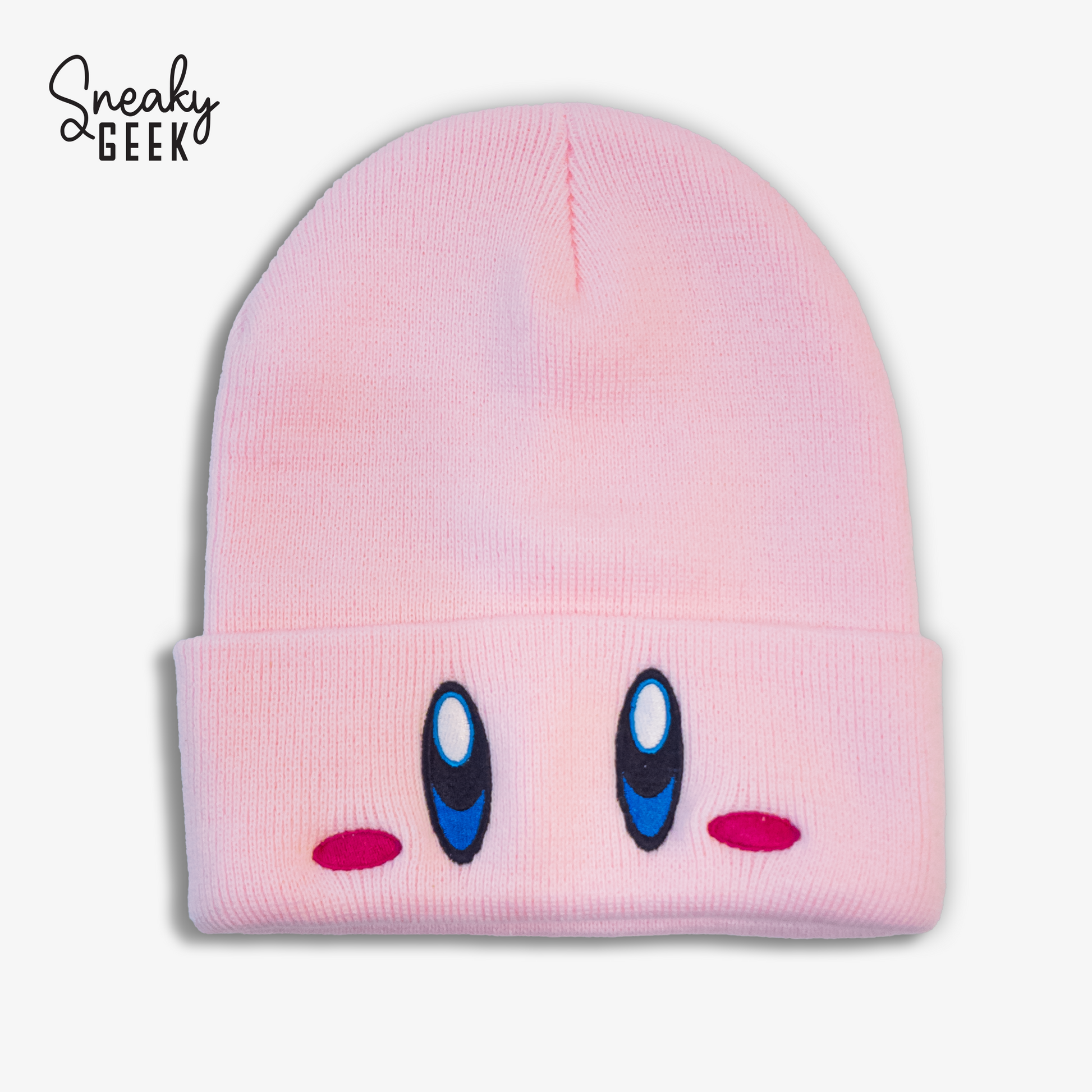 A pink knit hat featuring the face of Kirby, a popular video game character. The hat has Kirby's large blue eyes and small pink cheeks embroidered on the front.